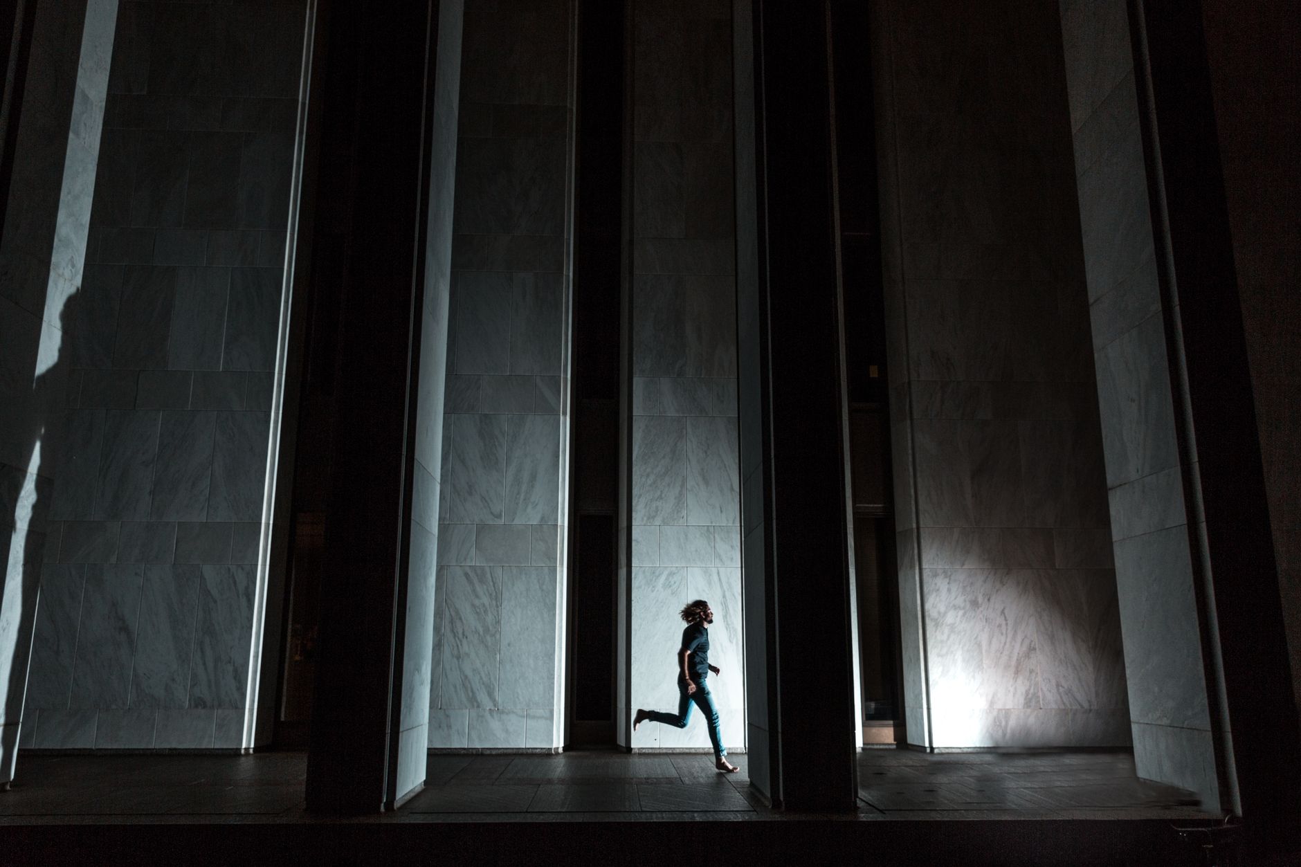 Silhouette marchant dans un couloir sombre la nuit